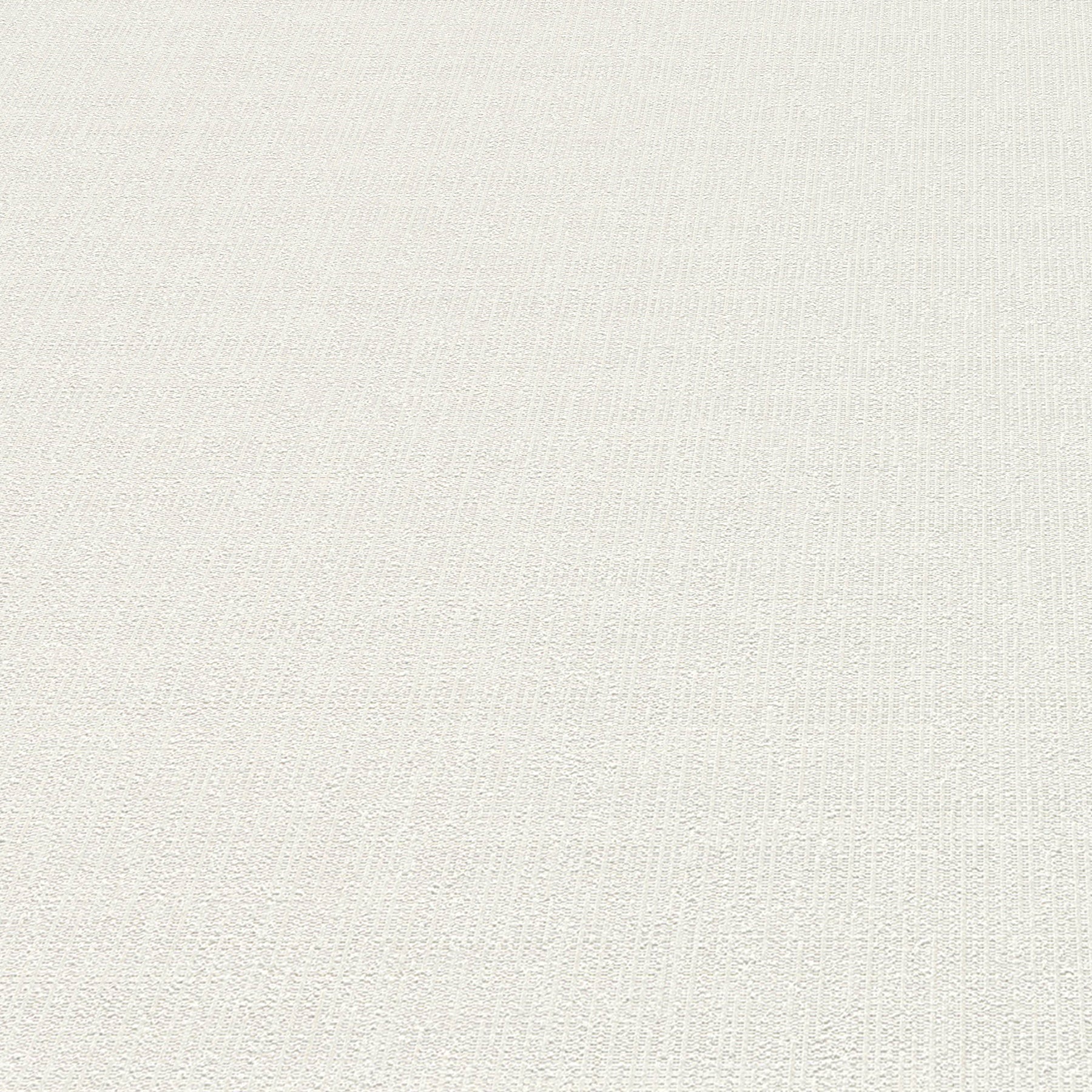 White wallpaper close-up showing a subtle textured loom-stria weave.