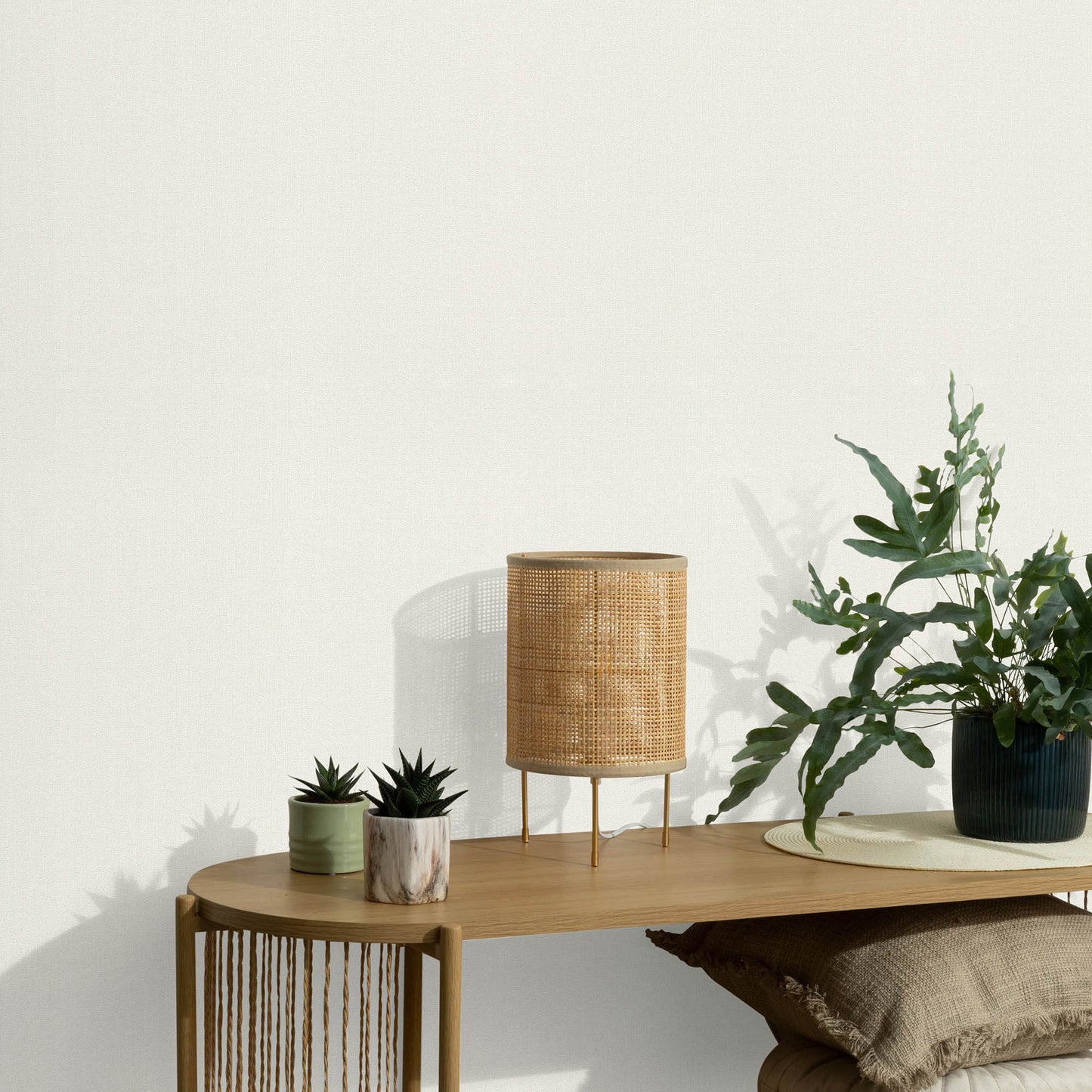White wallpaper with a soft loom-stria texture and an abstract traditional pattern.