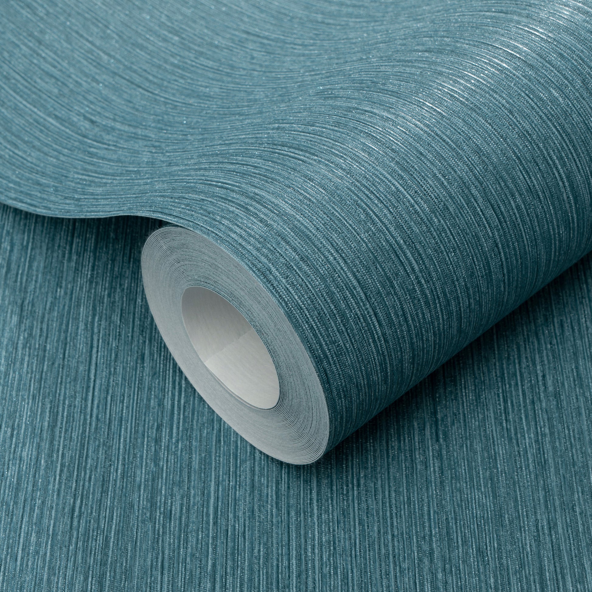 Teal textured wallpaper roll with fine linear brushed pattern; vinyl wallcovering.
