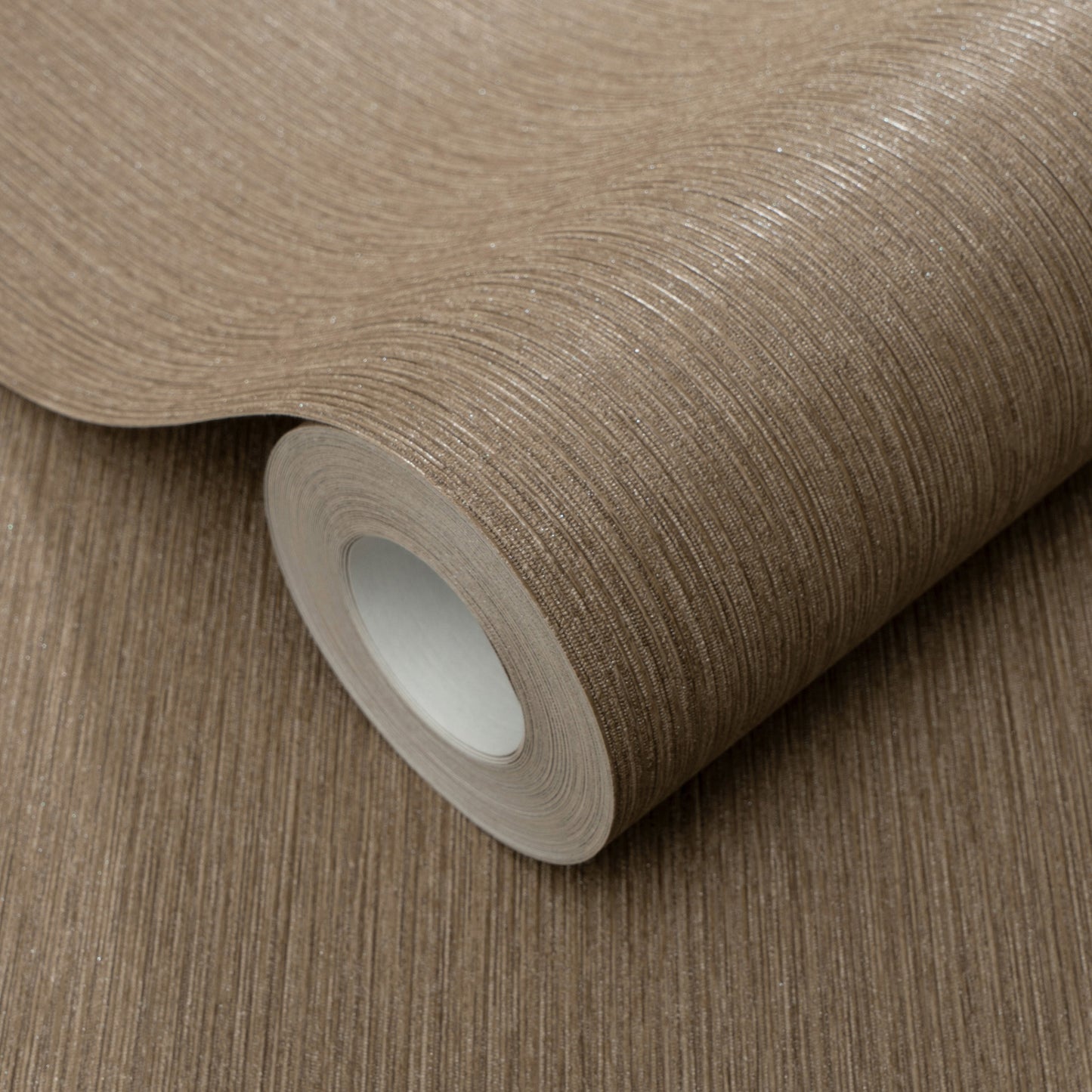 Taupe-brown textured wallpaper roll with fine metallic stripes and a silky sheen.