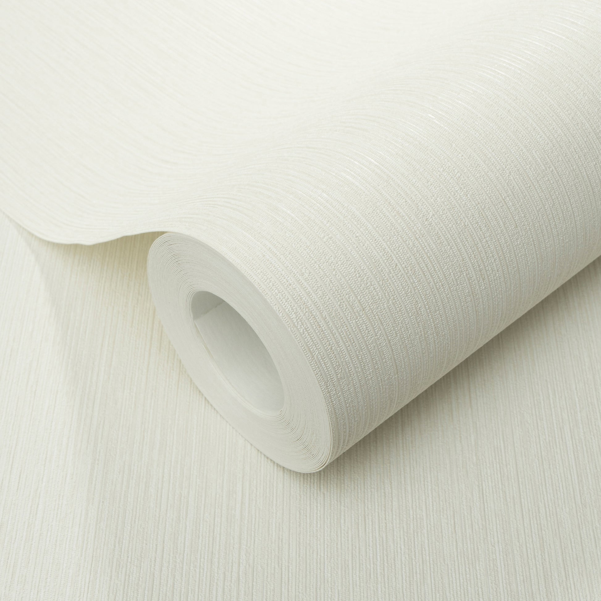 White textured wallpaper roll with linen-like grain, partly unrolled.