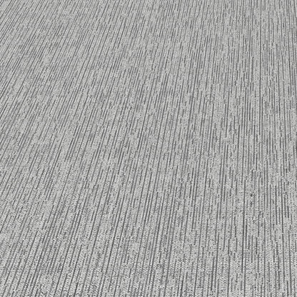 Gray-silver wallpaper with a subtle linear stria texture and abstract traditional pattern.