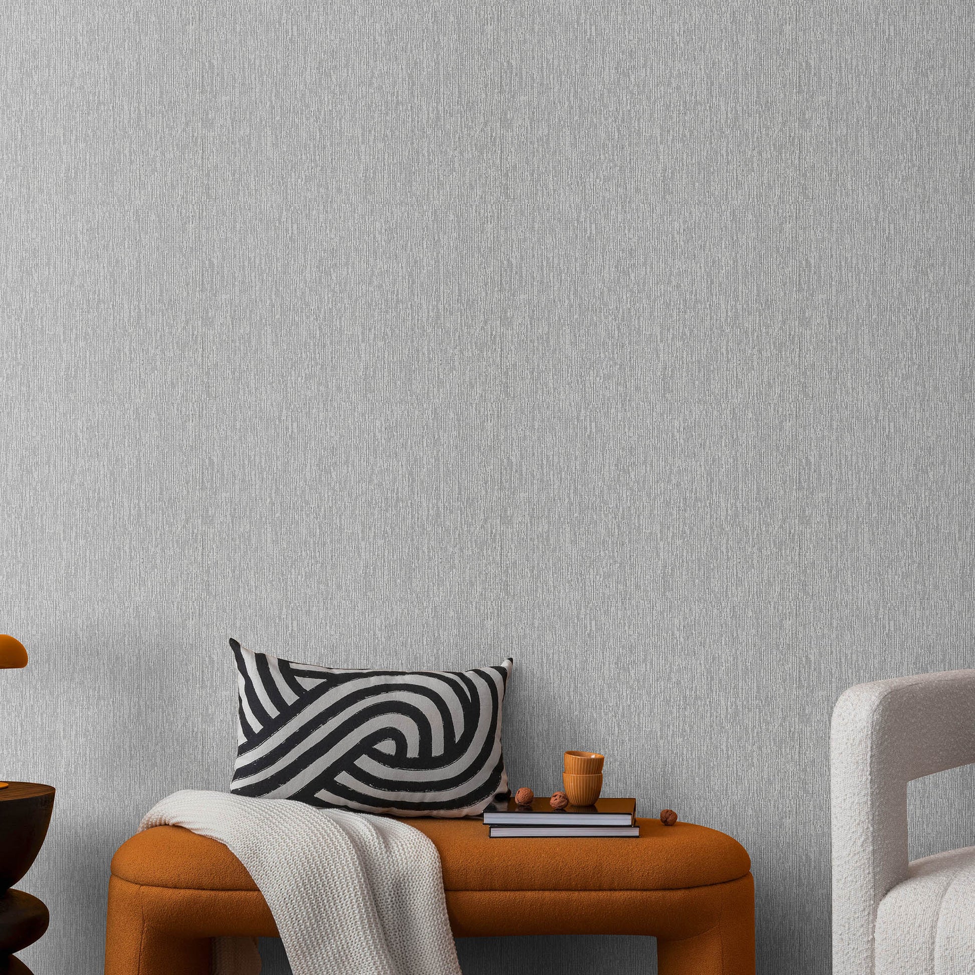 Silver wallpaper with a soft loom stria texture and an abstract traditional pattern.