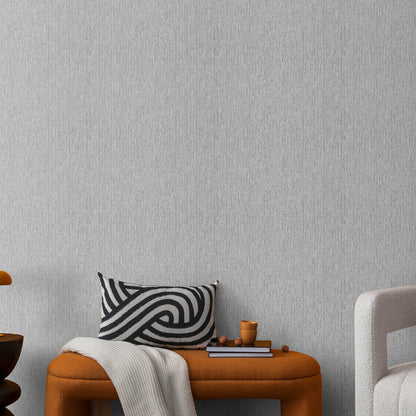 Silver wallpaper with a soft loom stria texture and an abstract traditional pattern.