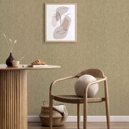 Natural wood round table with vertical-slat base, woven chair, wool ball, gold wallpaper with an abstract line art pattern.
