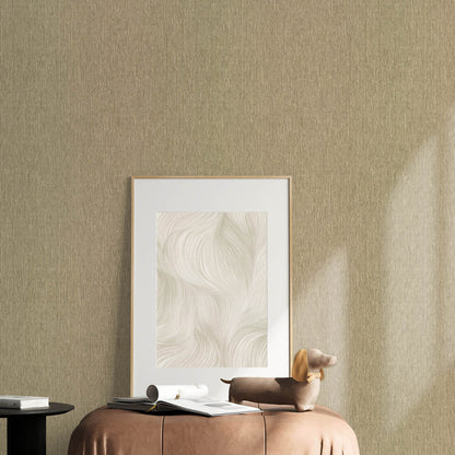 Beige textured wall with a gold-framed print, brown leather ottoman, magazines, rolled papers, and a tan dachshund sculpture.