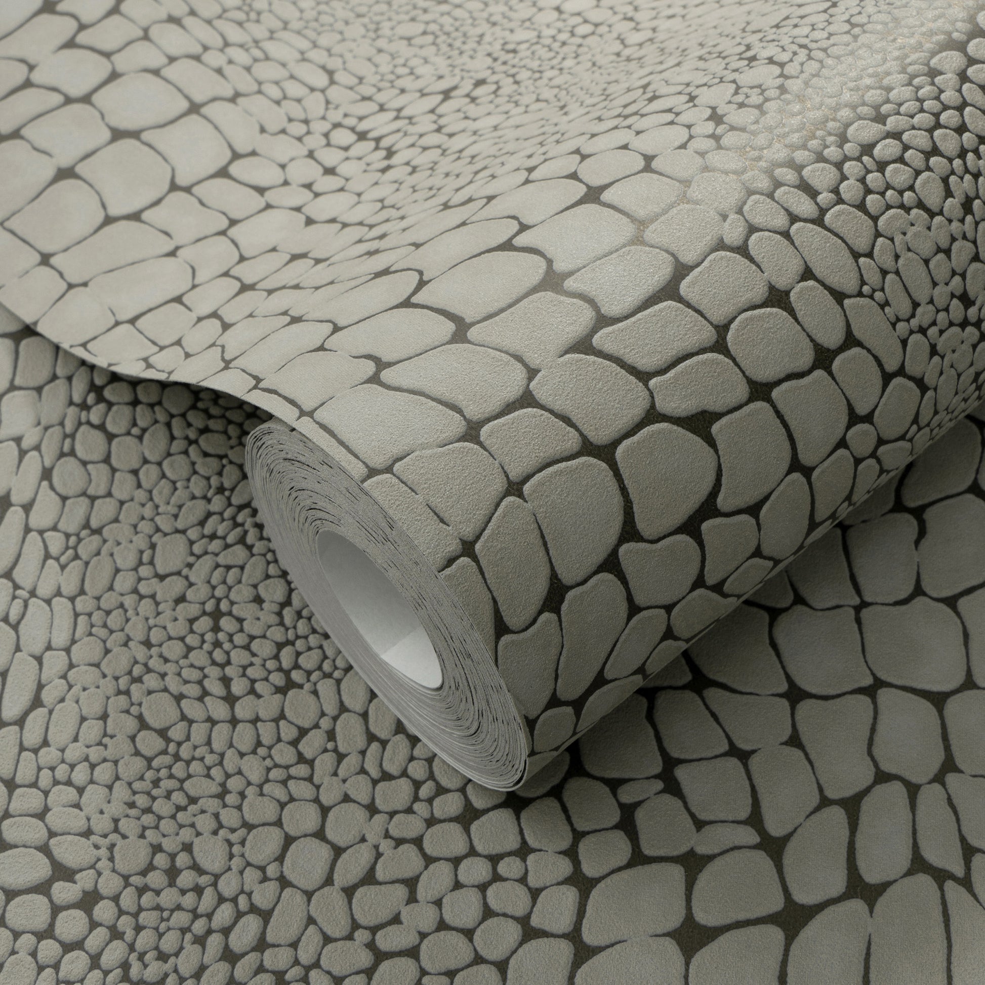 Gray pebble-pattern wallpaper roll with rounded stone shapes for a modern, textured wall covering.