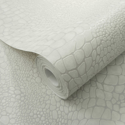 Light gray faux crocodile-skin wallpaper roll with embossed scale pattern, curled edge, decorative wall covering.