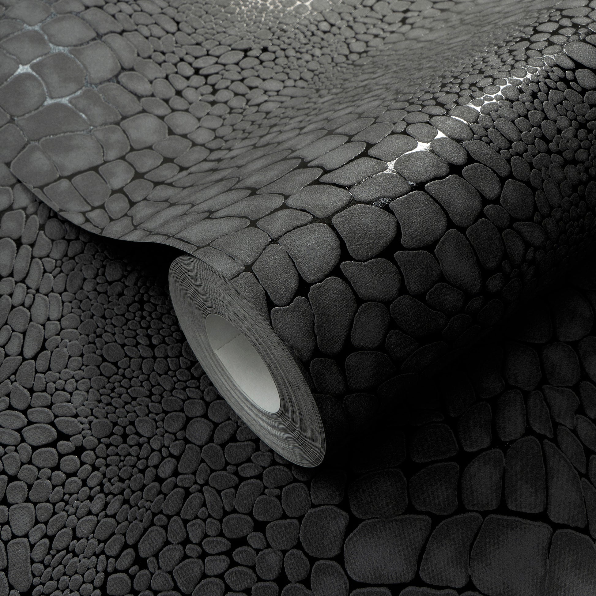 Gray pebble-textured wallpaper roll with faux-stone pattern, rolled edge, ideal for accent walls.