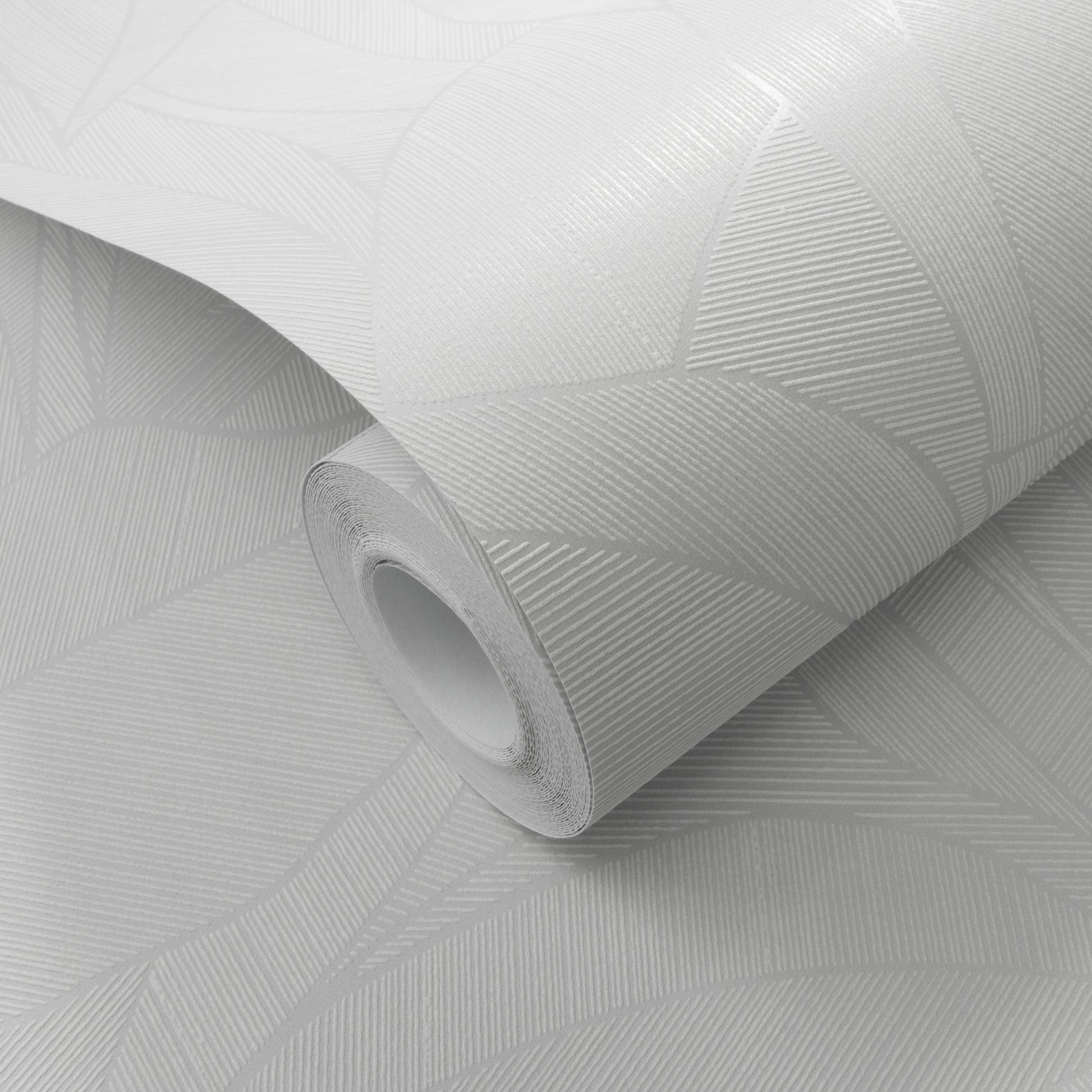 White wallpaper roll with a leaf pattern; rolled for wall decor.