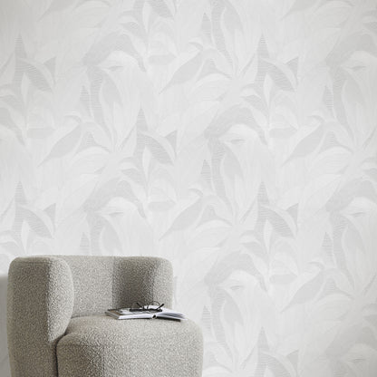 White wallpaper with a pale leaf pattern on the wall.