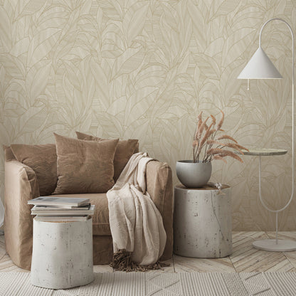 Beige sofa with cushions and throw, concrete stump tables, vase of dried grasses, white arc floor lamp, brown wallpaper with leaves in the background.
