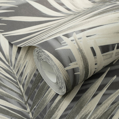 Rolled wallpaper with black palm leaves on a dark background.