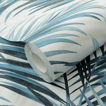 Rolled wallpaper with blue palm frond print on white background, tropical botanical design.