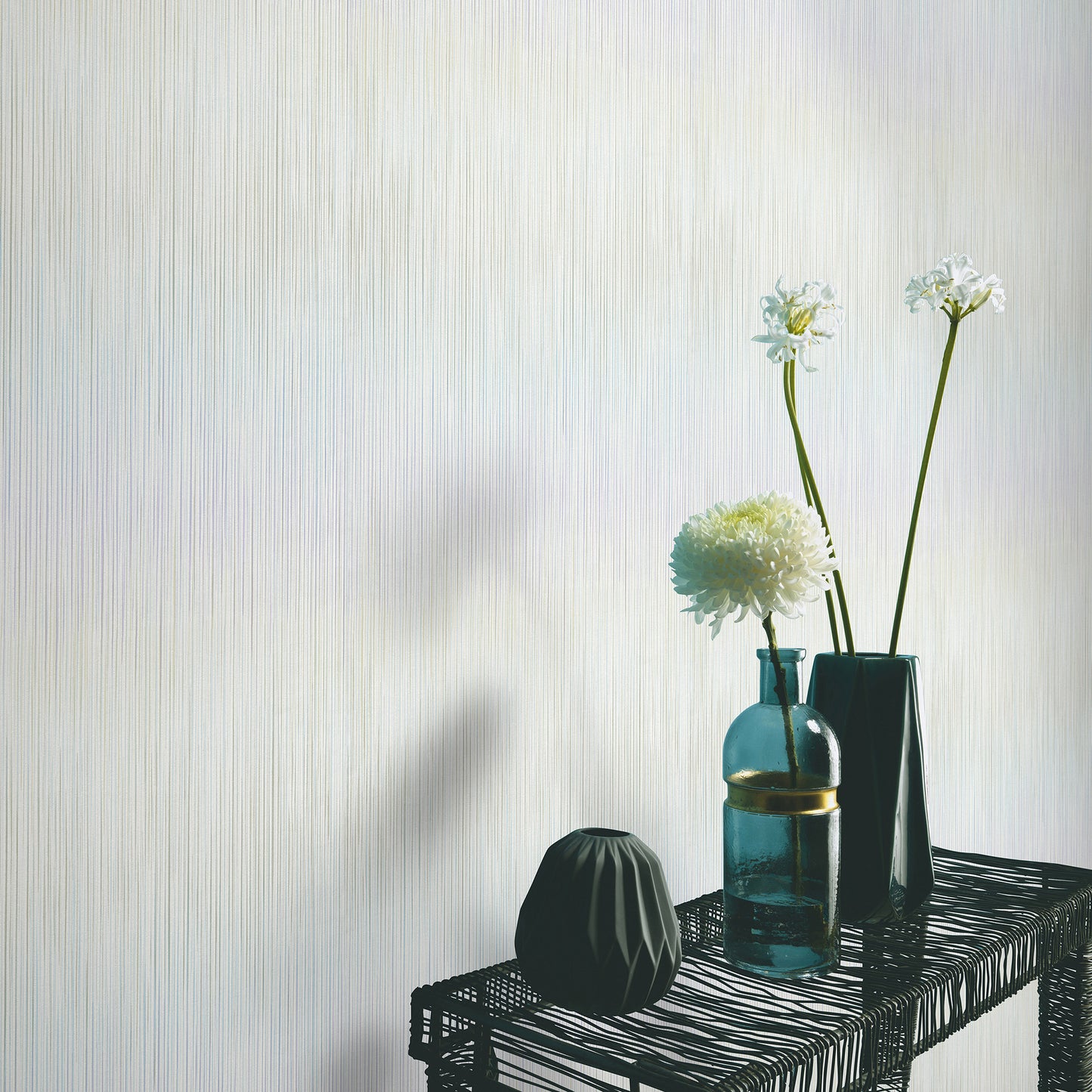 Green wallpaper with a raised stria texture in a traditional pattern; close-up of the textured wall surface.
