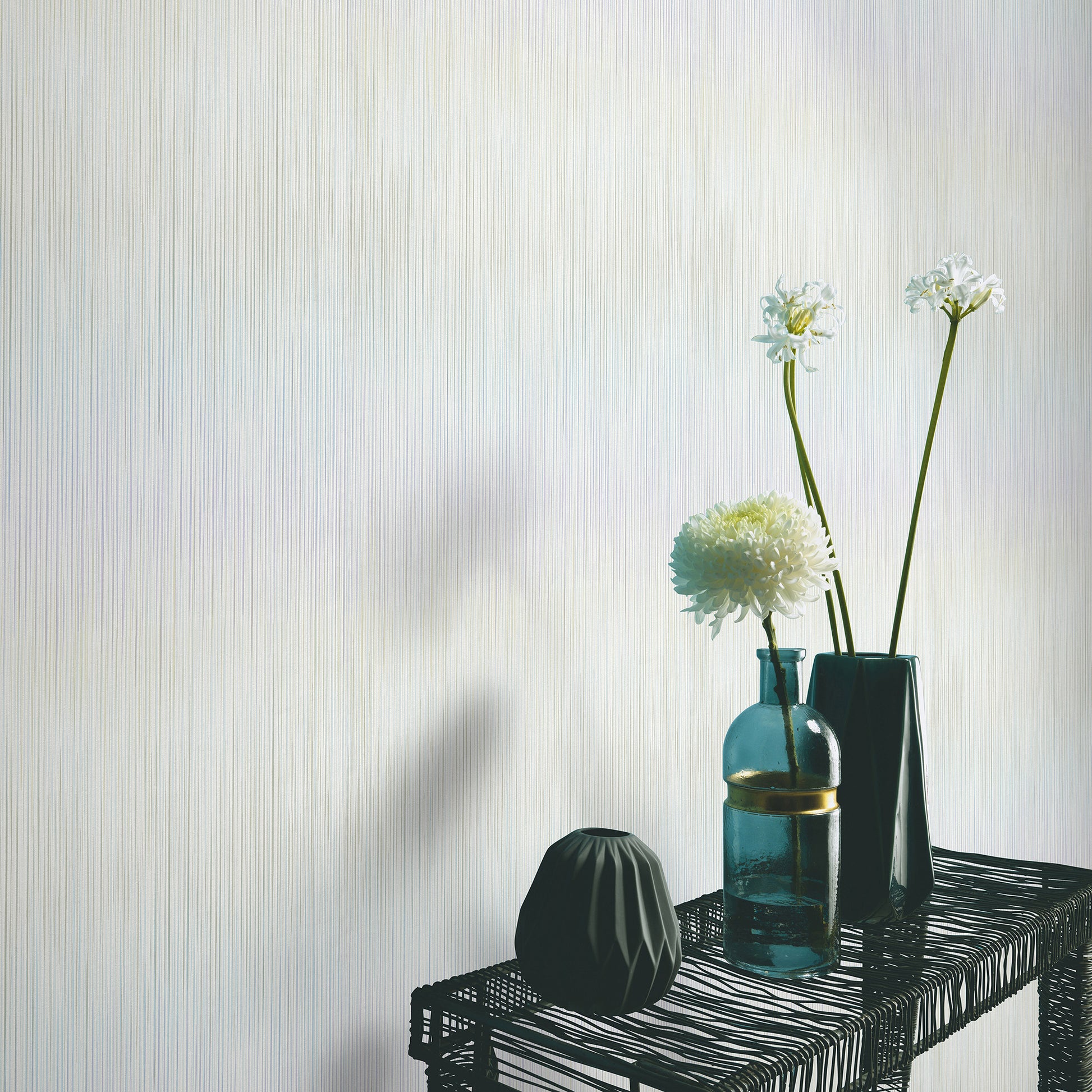 Green wallpaper with a raised stria texture in a traditional pattern; close-up of the textured wall surface.