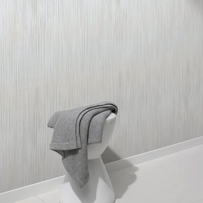 Taupe raised-stria wallpaper with a traditional pattern on a wall.