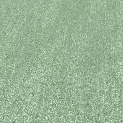 Close-up of light green textured wallpaper with a subtle raised linear weave.