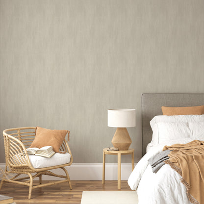 Wall covered in brown raised-texture traditional wallpaper; neutral bedroom setting visible in background.