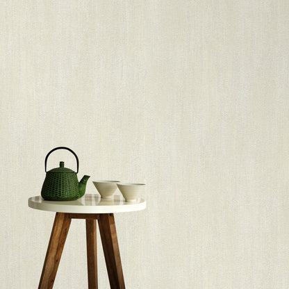 Cream wallpaper with raised texture and a traditional pattern.