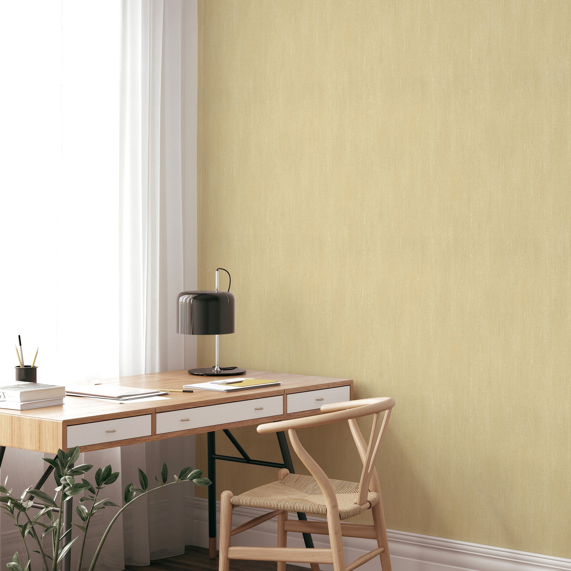 Pale yellow wall with raised-texture sepia wallpaper pattern; part of a sunlit room with a wooden desk and chair visible.