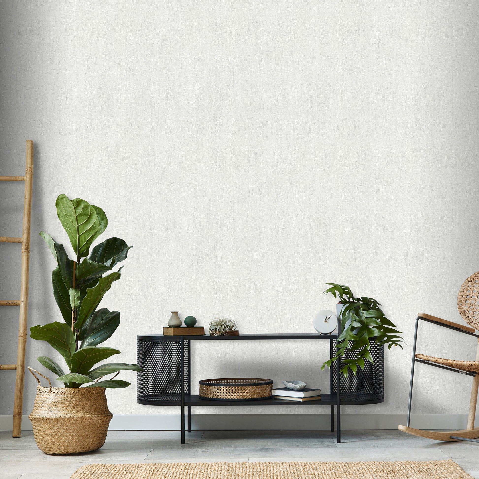 Close-up of light gray raised-texture wallpaper with a traditional pattern.