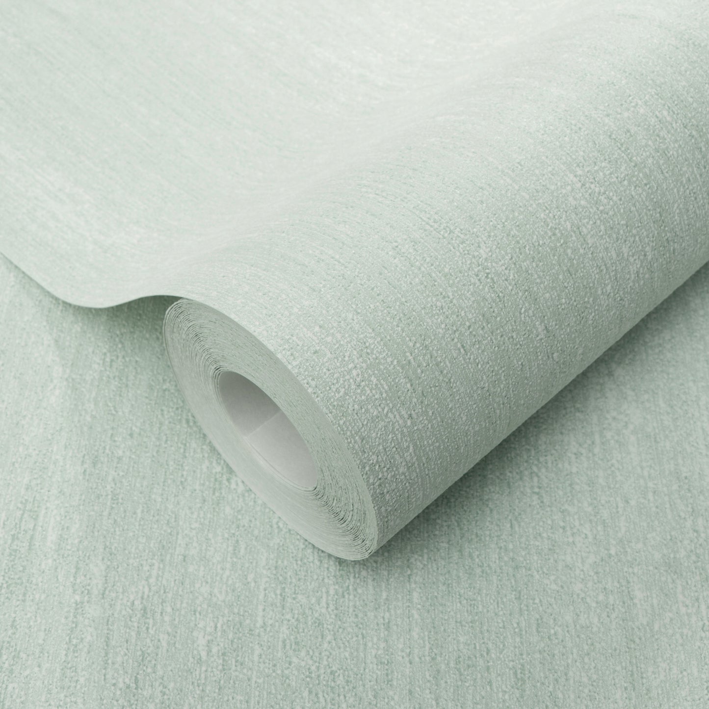 Mint green textured wallpaper roll with a subtle linen pattern, curved edge exposing the inner tube.