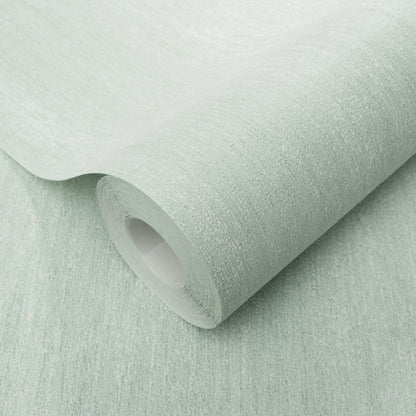 Mint green textured wallpaper roll with a subtle linen pattern, curved edge exposing the inner tube.