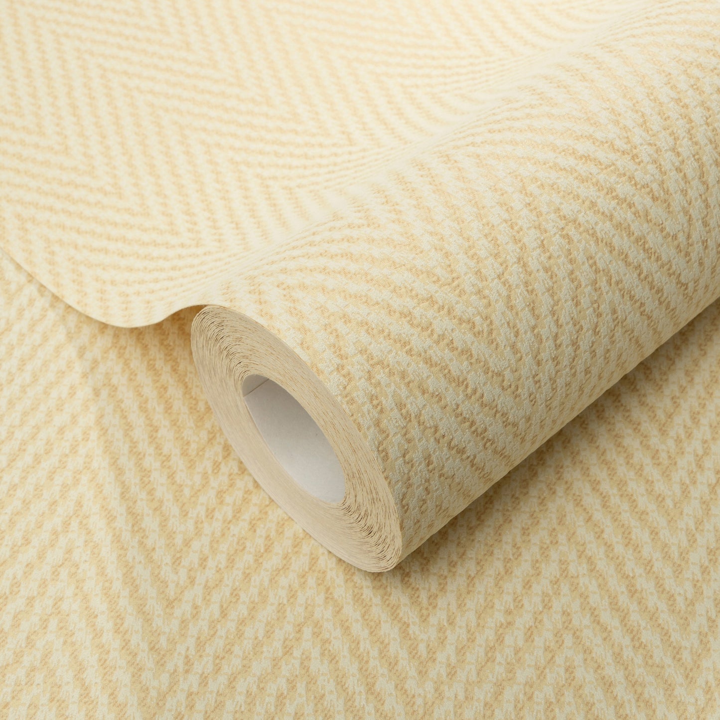 Yellow chevron-pattern wallpaper roll with subtle herringbone texture, rolled around a white cardboard core.