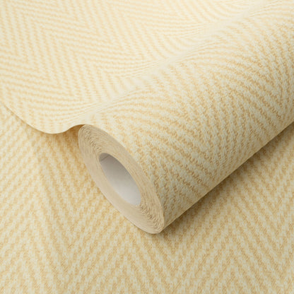 Yellow chevron-pattern wallpaper roll with subtle herringbone texture, rolled around a white cardboard core.