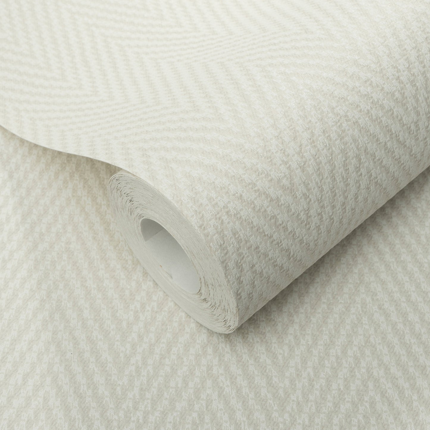Cream herringbone textured wallpaper roll with a subtle zigzag pattern and a soft fabric-like finish.