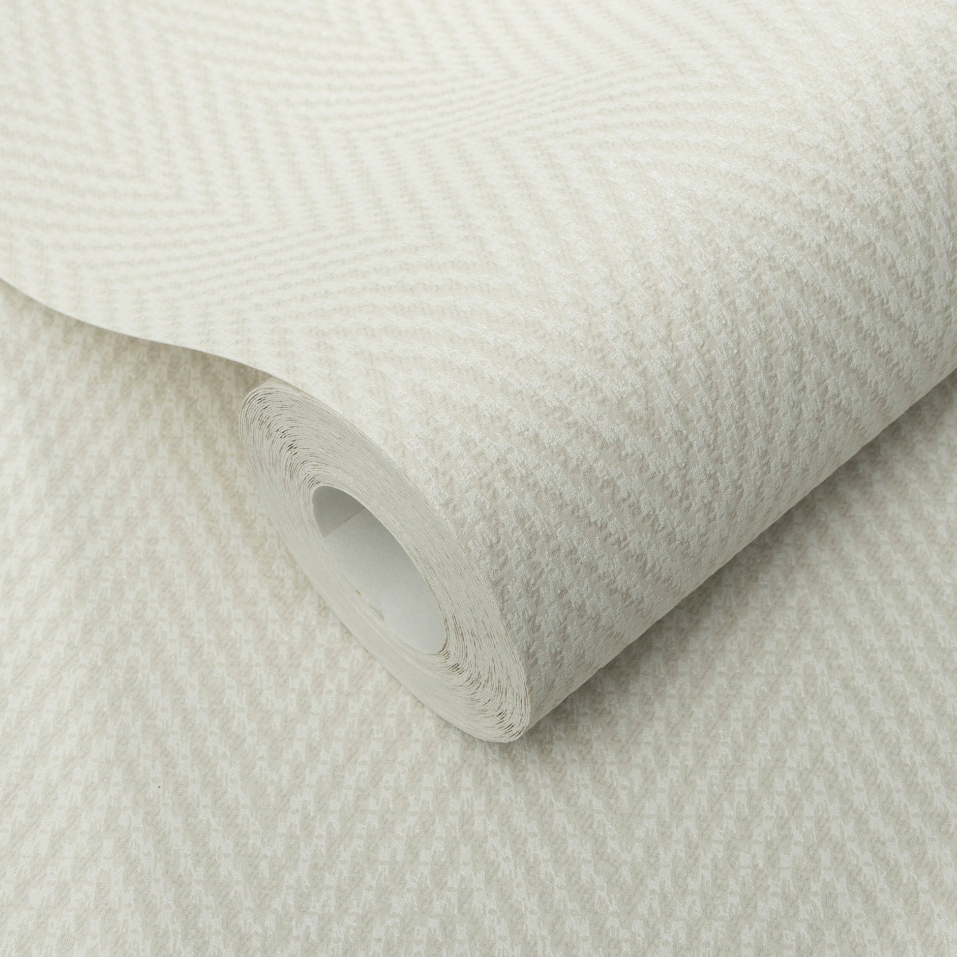 Cream herringbone textured wallpaper roll with a subtle zigzag pattern and a soft fabric-like finish.