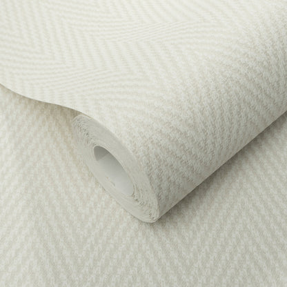 Cream herringbone textured wallpaper roll with a subtle zigzag pattern and a soft fabric-like finish.