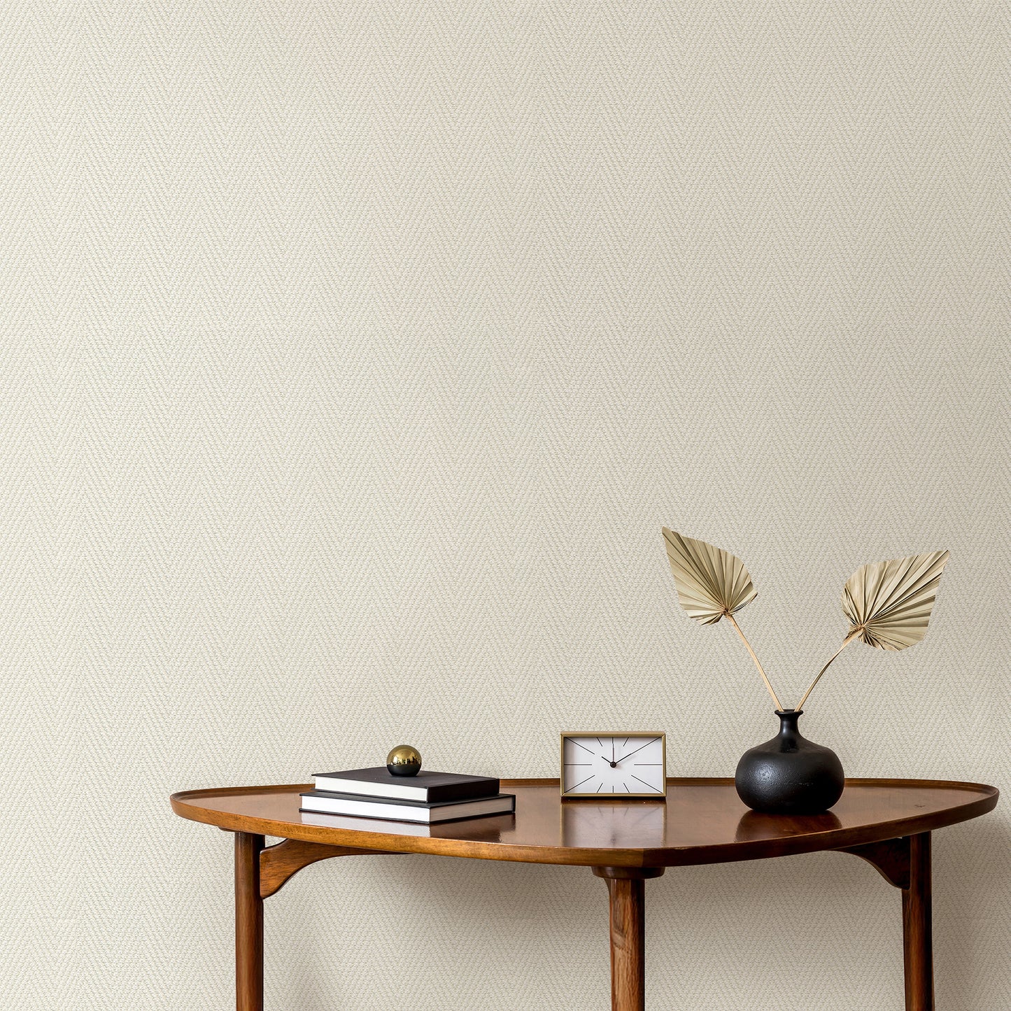 Cream wallpaper with a chevron stripe pattern on a beige textured wall.