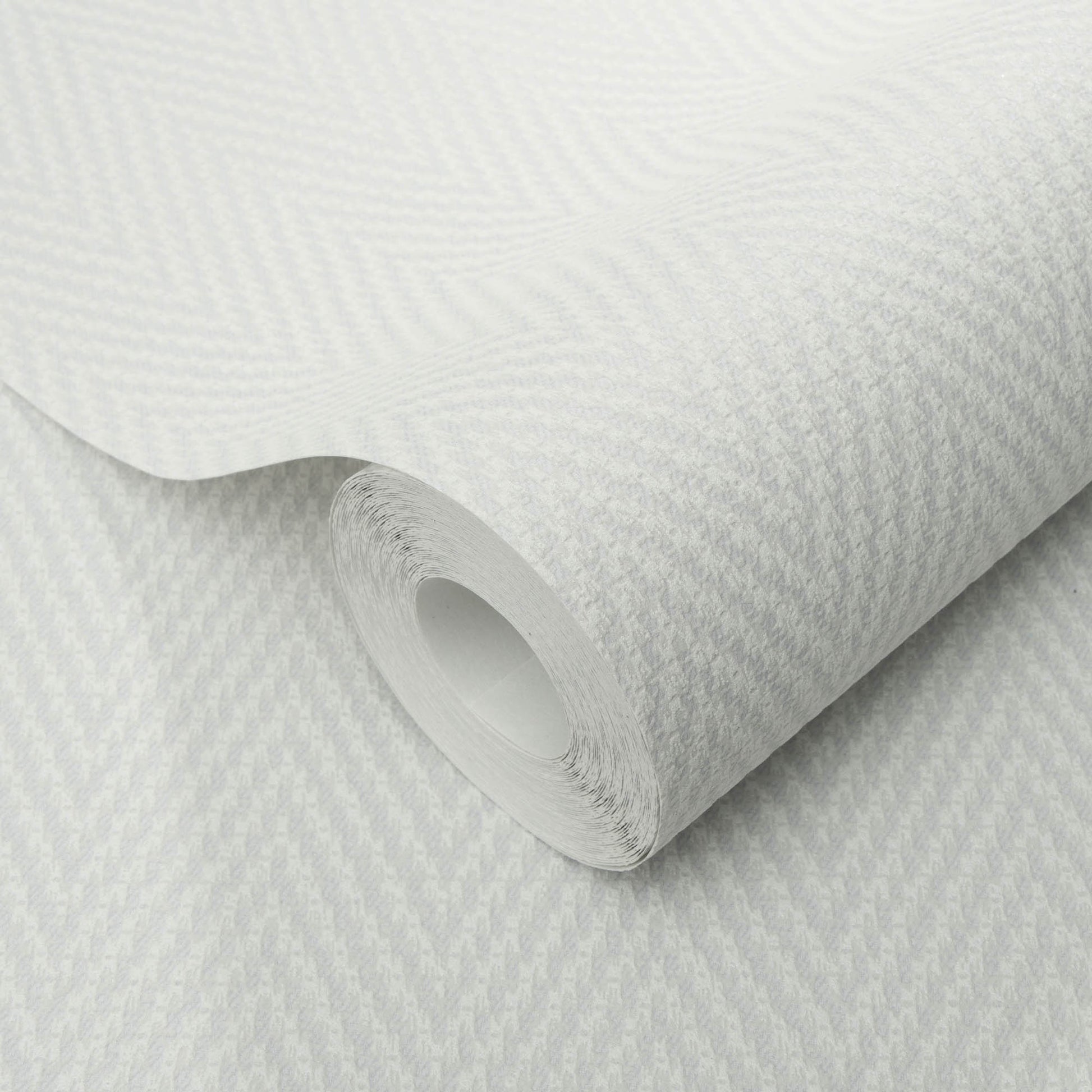Gray chevron stripe textured wallpaper, rolled with the inner tube visible.