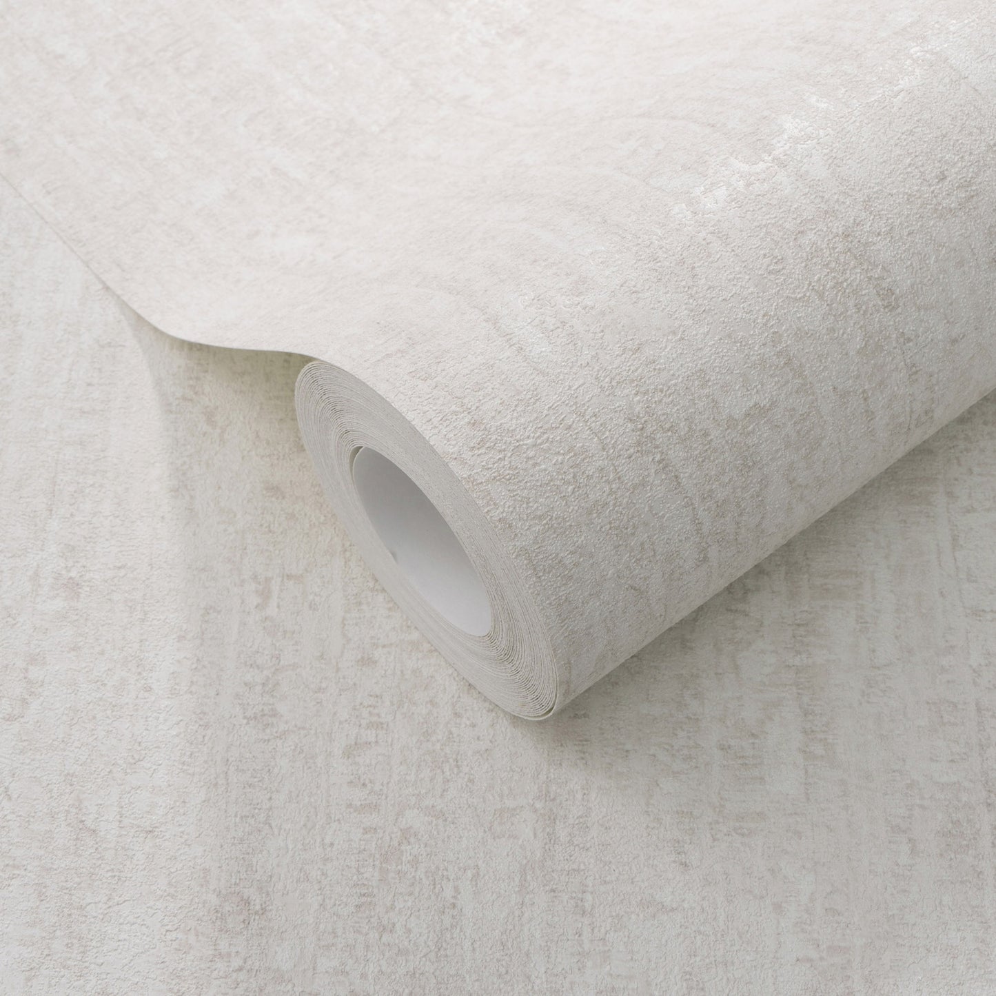Rolled light beige textured wallpaper with a subtle stone-like pattern.