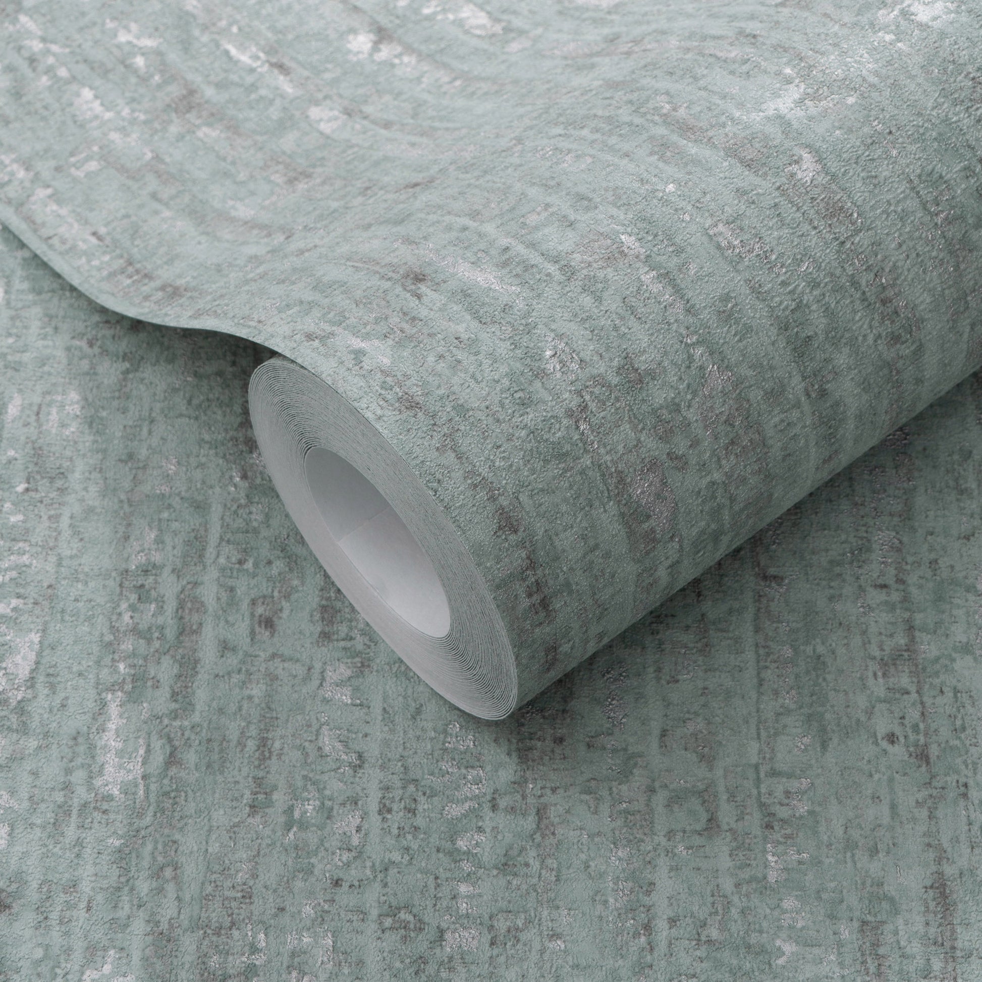 Sage green distressed wallpaper roll with subtle white marbling and fabric-like texture; core visible.