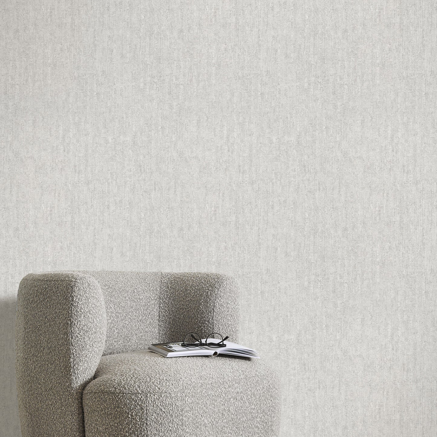 Gray wallpaper with a traditional textured pattern; close-up of the wallpaper design.