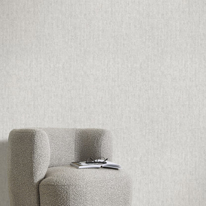 Gray wallpaper with a traditional textured pattern; close-up of the wallpaper design.