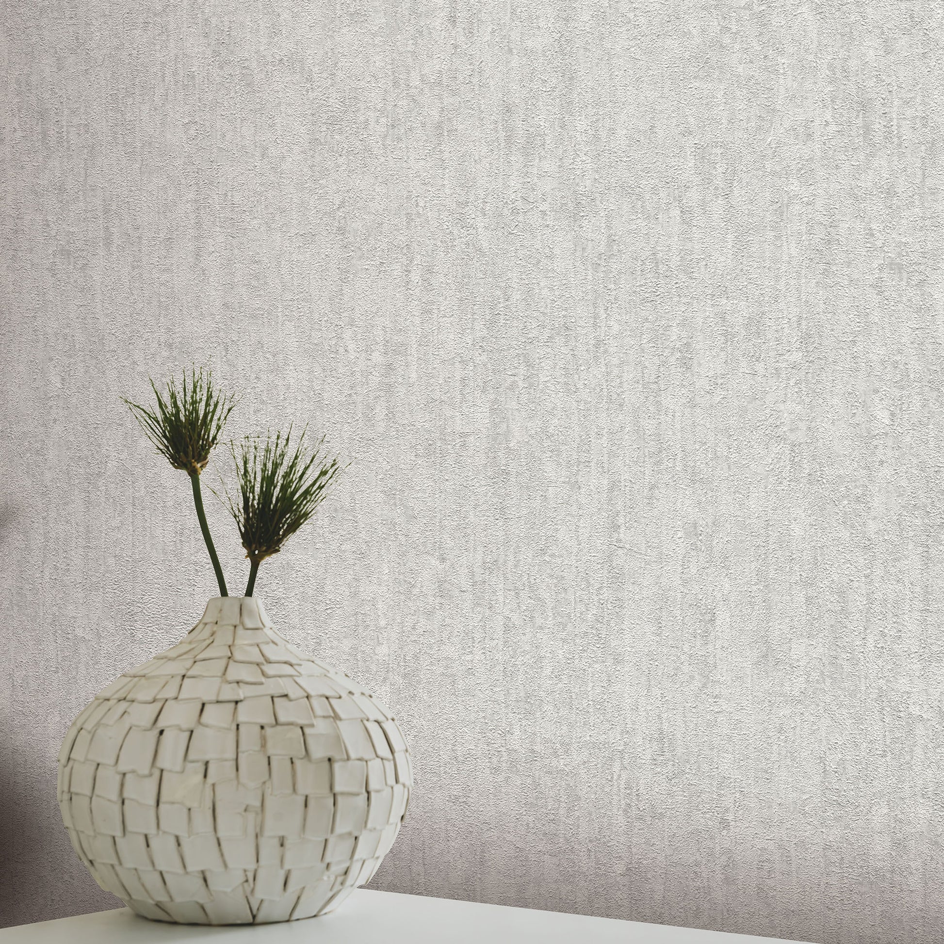 Gray textured wallpaper with a traditional artisan pattern.