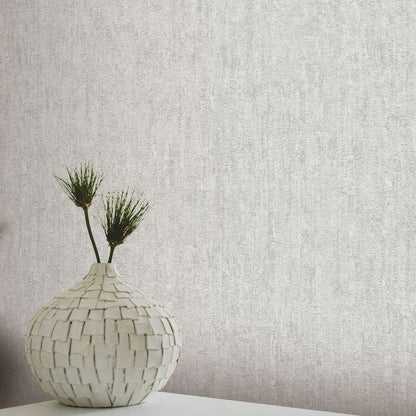 Gray textured wallpaper with a traditional artisan pattern.