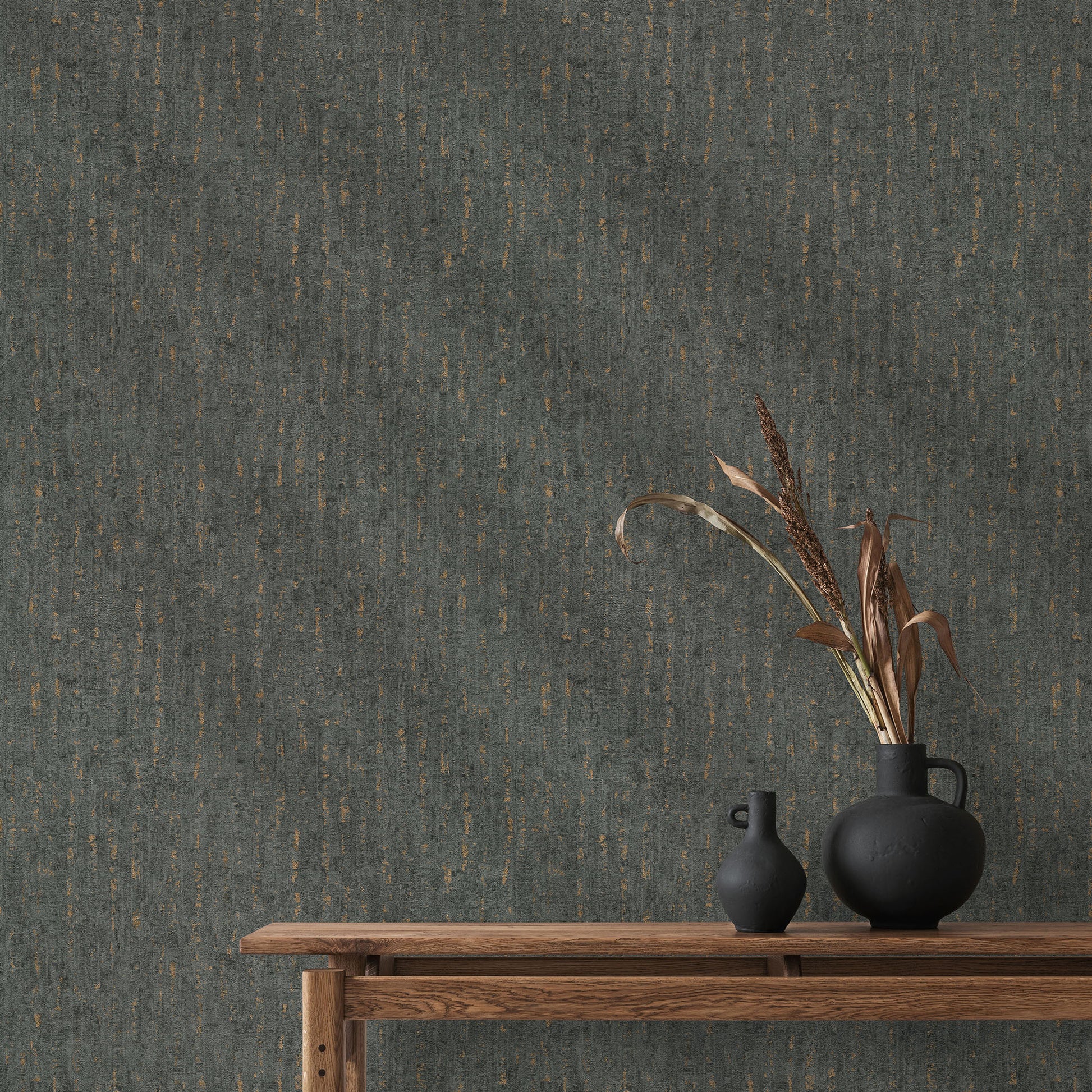 Wooden console table with two matte black ceramic vases and dried grasses against black textured wallpaper.