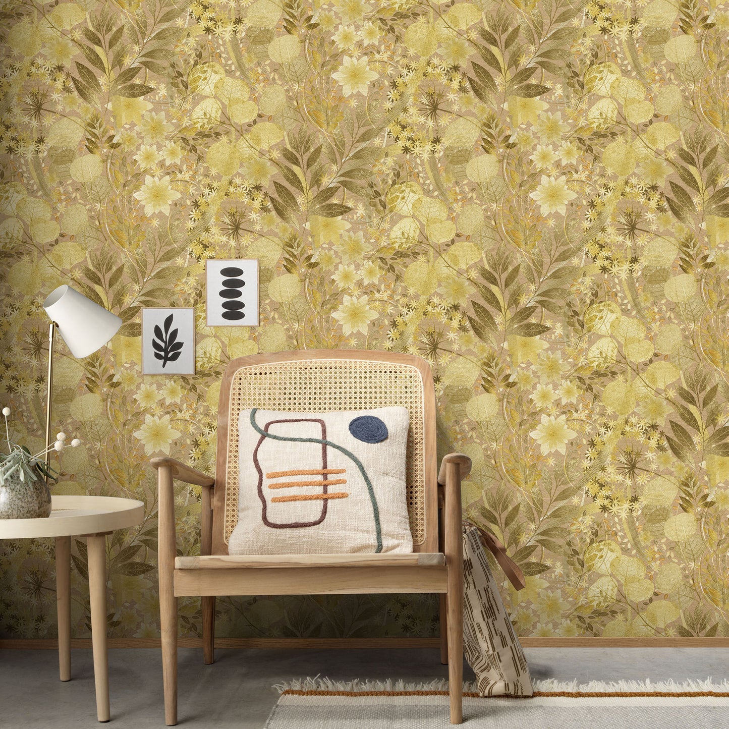 Mid-century wooden armchair with cane back, abstract-pattern cushion, beside a white side table and lamp against yellow floral wallpaper.