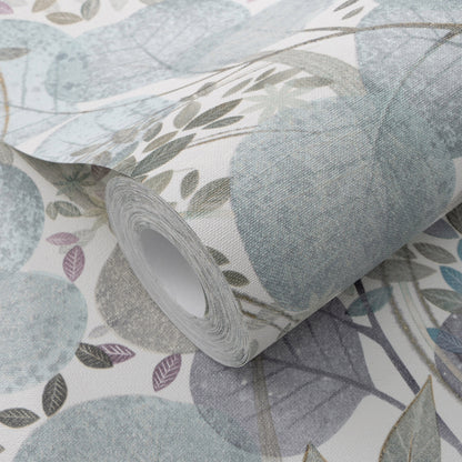 Roll of botanical wallpaper with muted blue and sage leaves on a light background, partially unrolled.