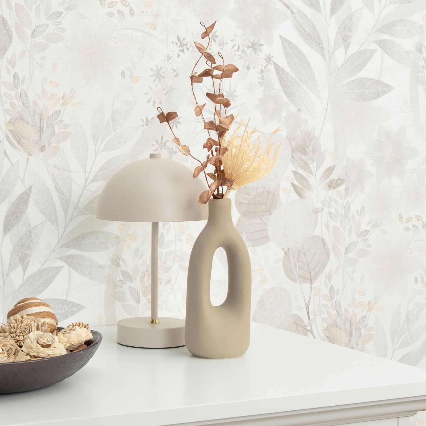 Gray floral wallpaper on a wall.