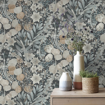 Muted blue-beige floral wallpaper with vines; wooden dresser top displays ceramic vases and a woven plant pot.