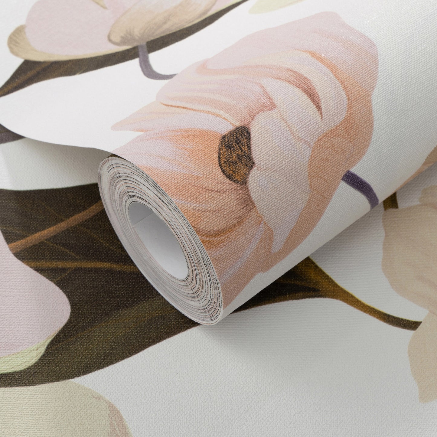 Rolled wallpaper sample with soft pink-peach flowers and brown stems.