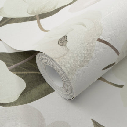 Rolled wallpaper featuring large white orchid blooms on a pale green-gray background, with a textured matte finish.