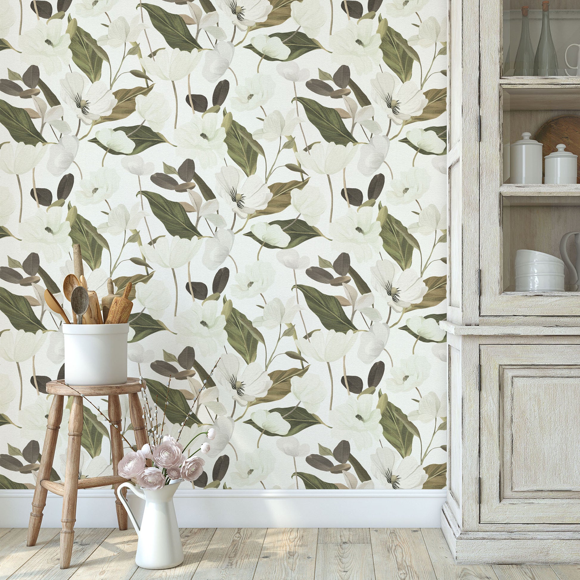 Floral wallpaper featuring white flowers and green leaves, paired with a wooden stool, white ceramic pot, and distressed wood cabinet.