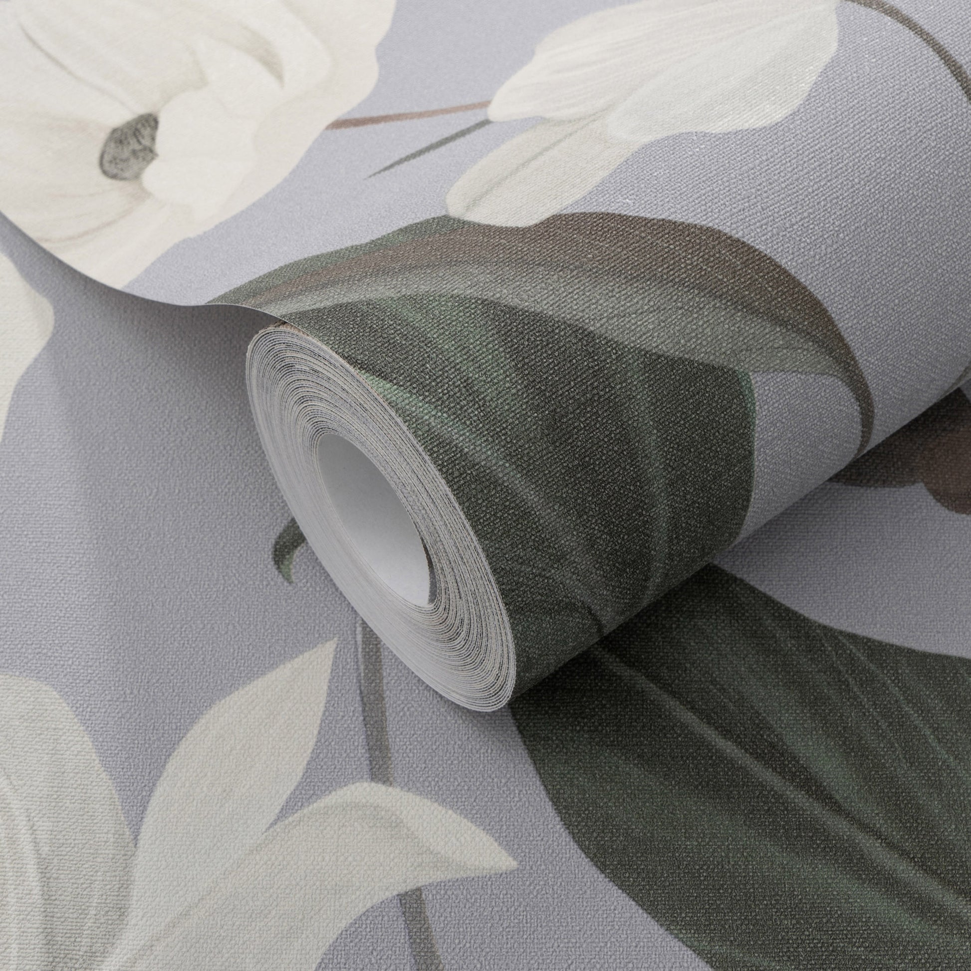 Rolled wallpaper with a soft lavender-gray background, featuring white flowers and dark green leaves.